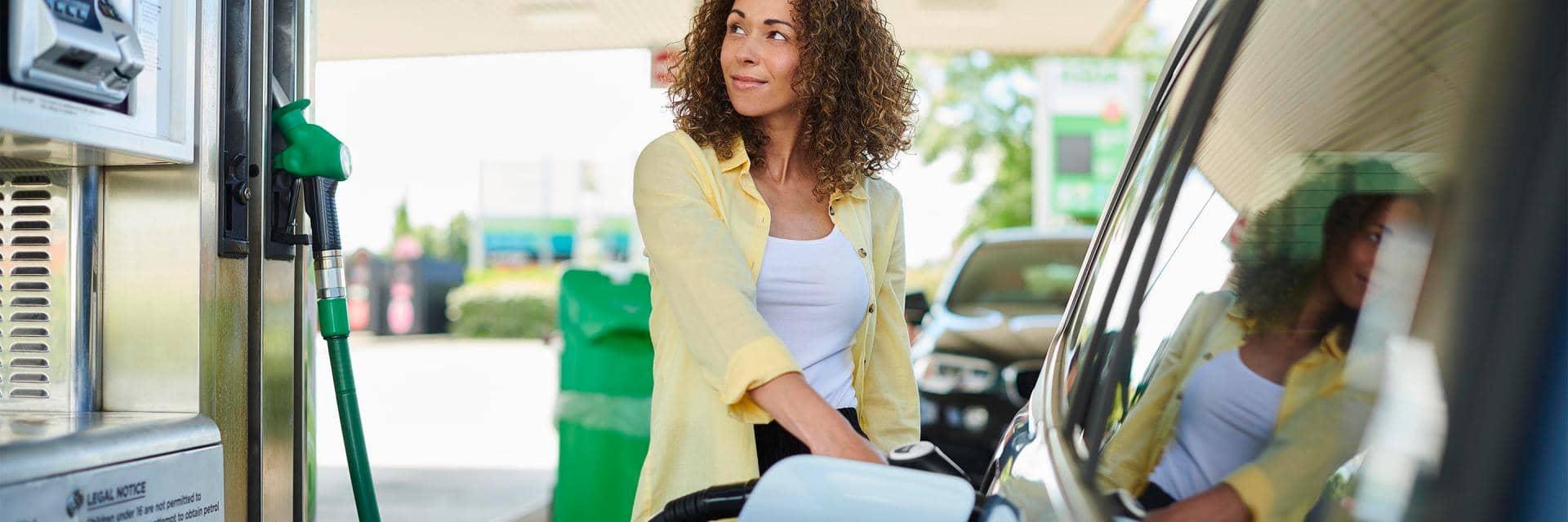 Woman filling car up at a petrol station