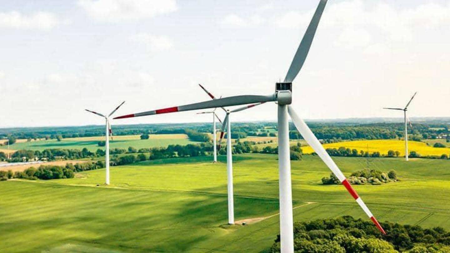 Number of wind turbines surrounded by green fields