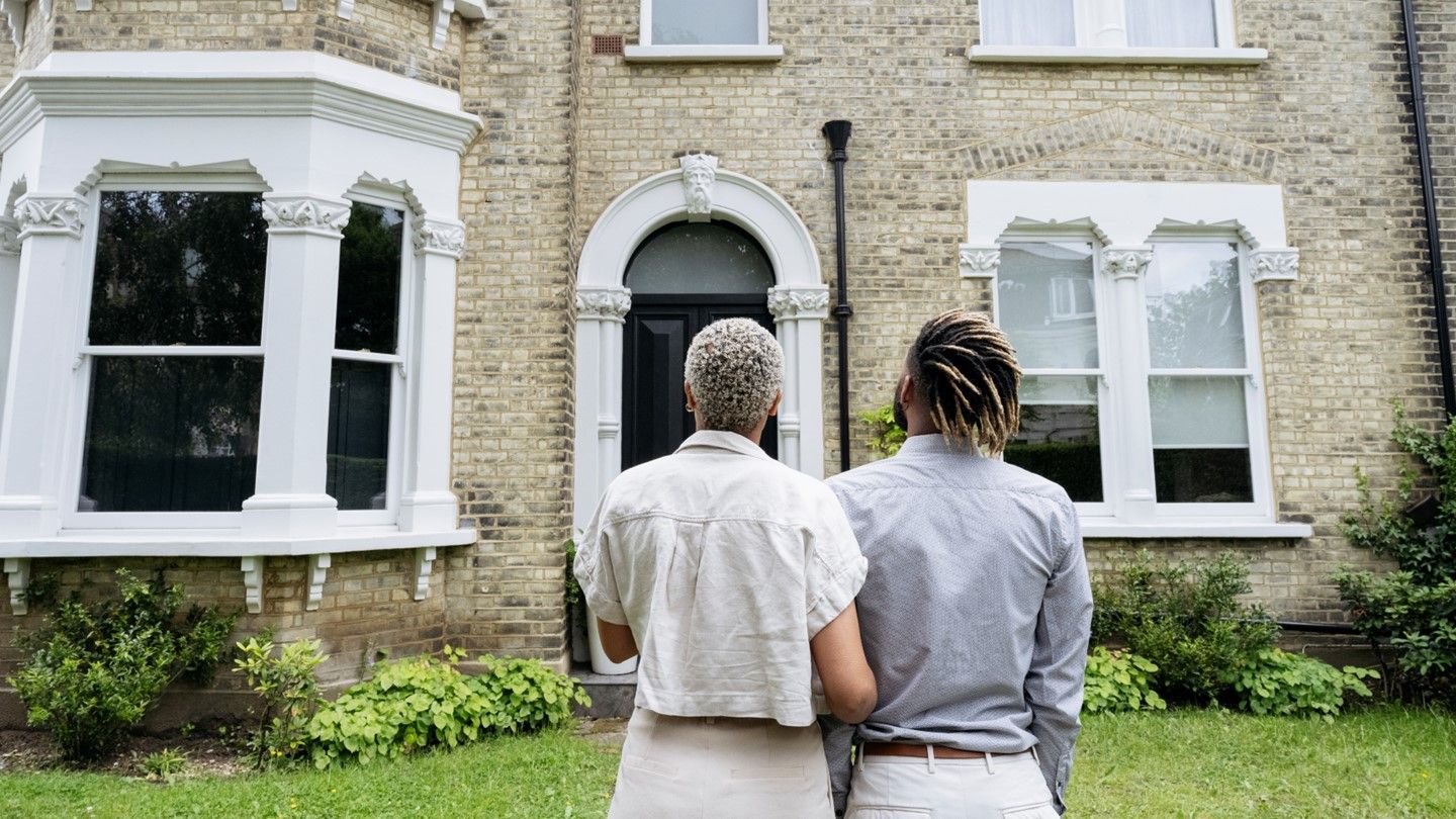 A couple looks up at their new property