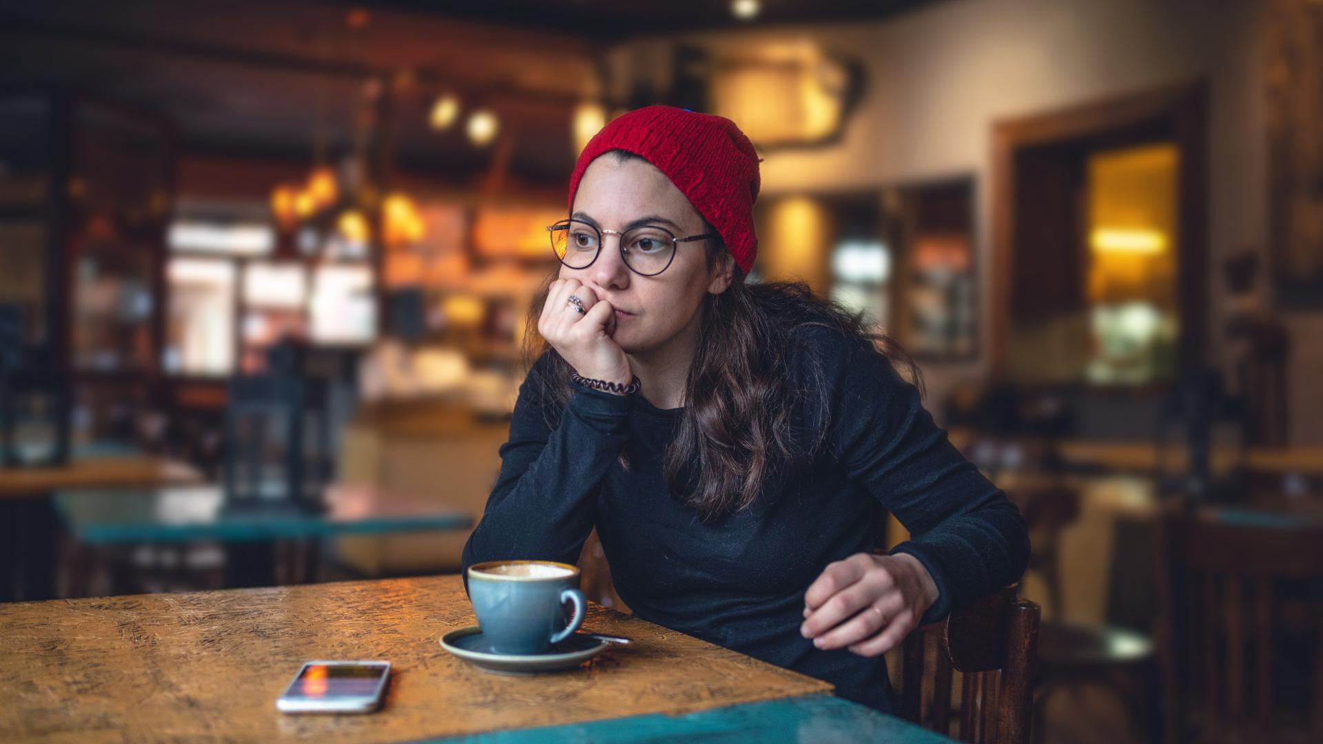 Student at cafe with mobile phone