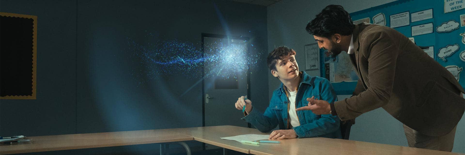 Student being helped by an older man within a classroom, illustrated by a glowing  'spark' 