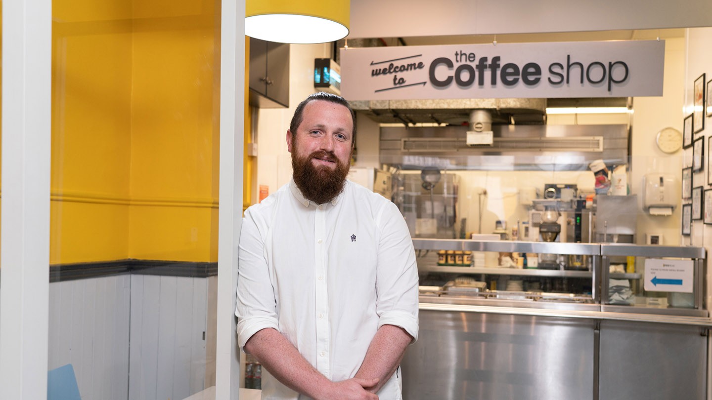Conor stands in front of the Focus Ireland Coffee Shop kitchen