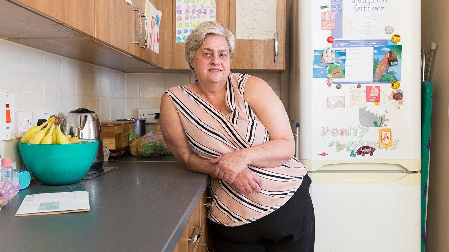 Nicola, who has been supported by Family Action, standing in her kitchen.