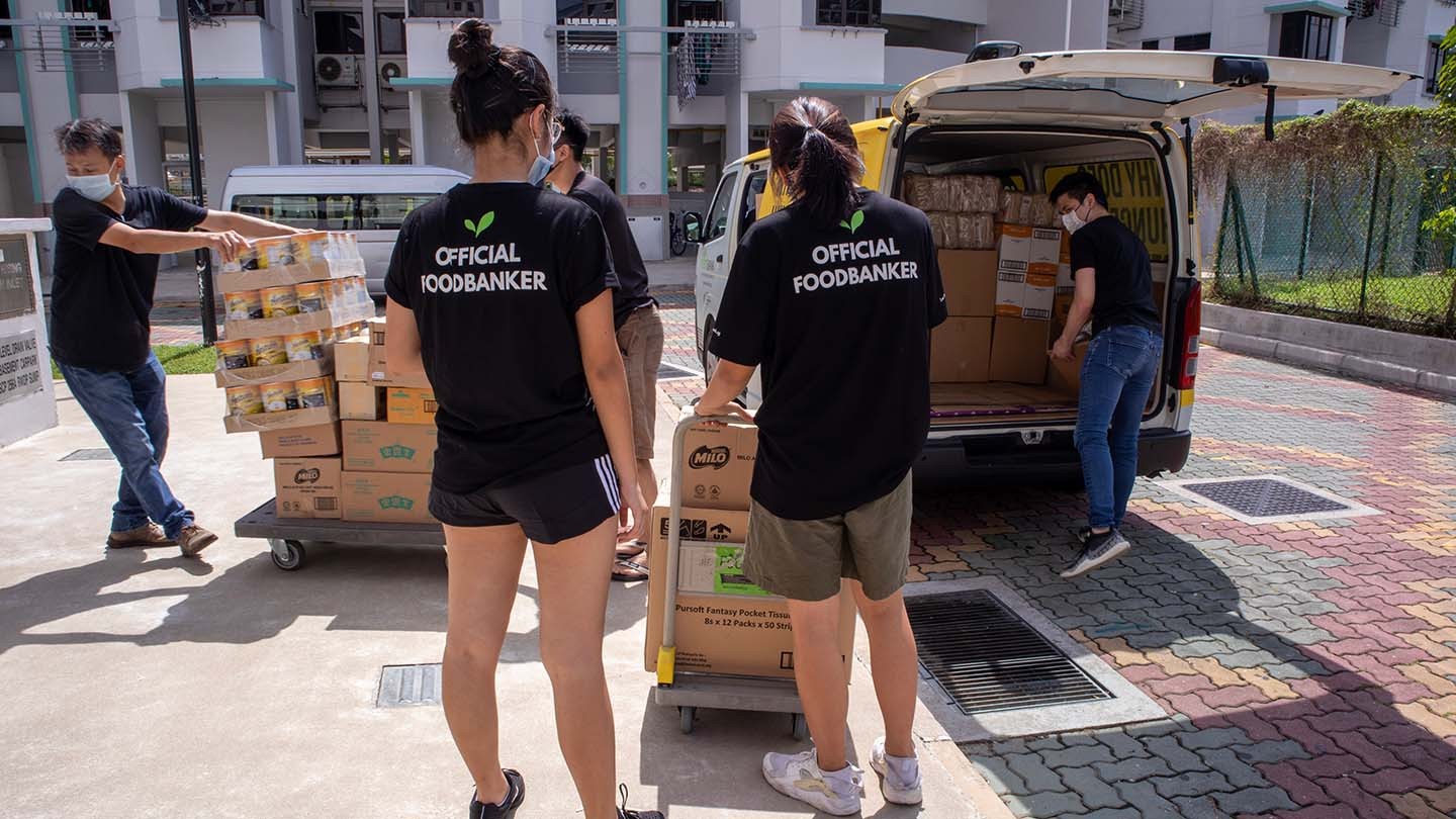 The Food Bank Singapore volunteers sort food donations for distribution.