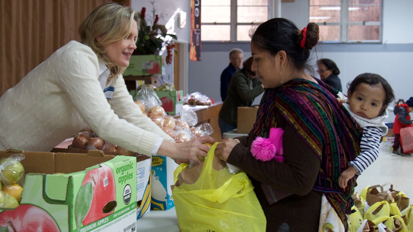 Beneficiaries collect food at the Interfaith Food Pantry Network.