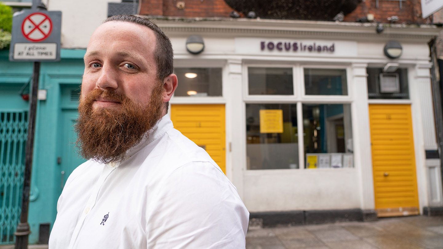 Conor Roe, Project Leader for the Focus Ireland Coffee Shop, stands in front of the charity building.