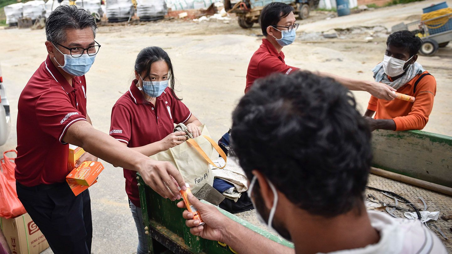 HealthServe’s Michael Cheah delivering essentials to migrant workers in Singapore. 