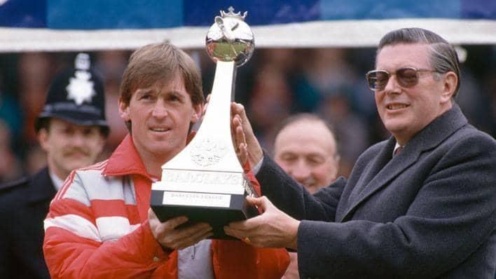 Liverpool manager Kenny Dalglish receives the Barclays Division One trophy from the then Barclays Chairman John Quinton at Anfield on 1 May 1988