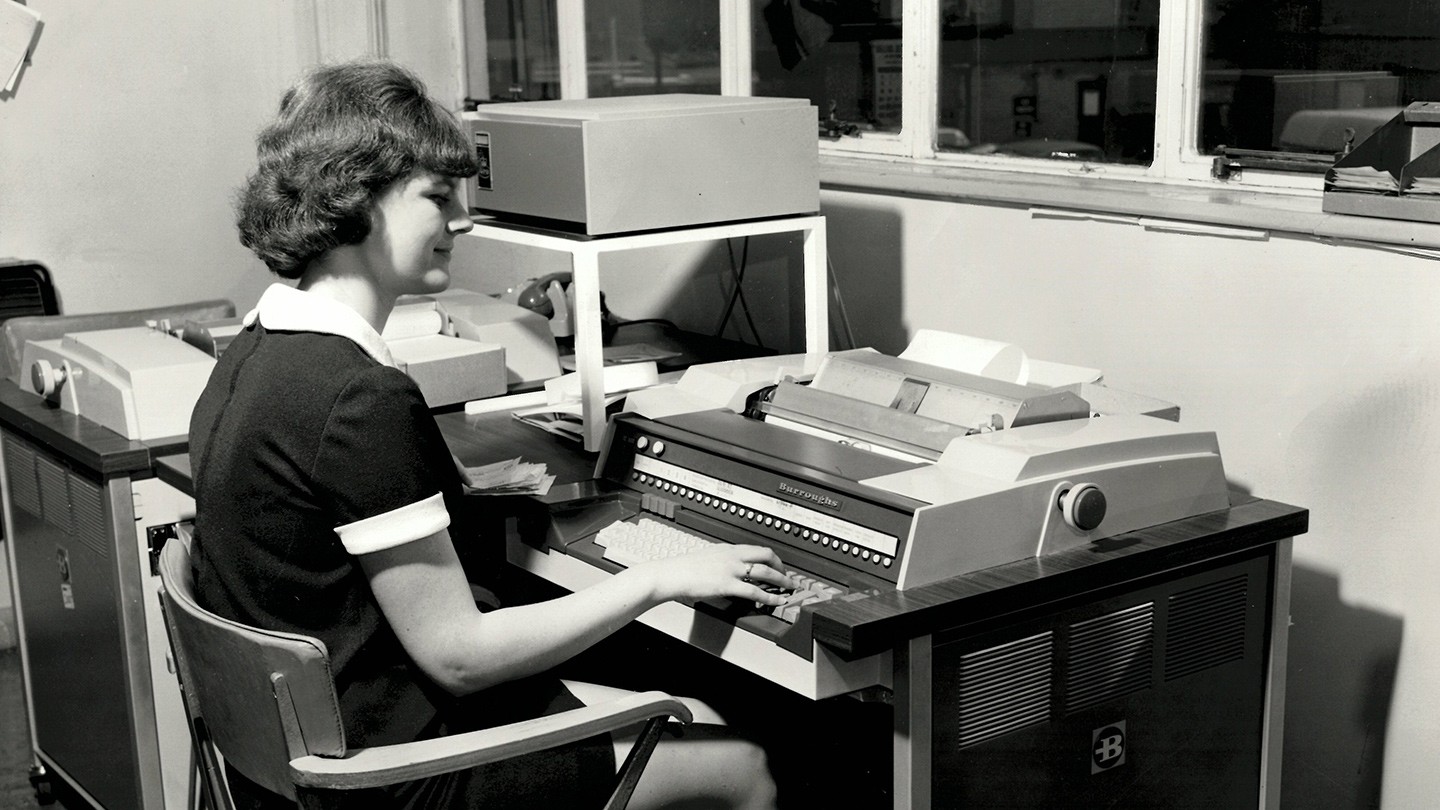 A Barclays machine operator feeds information into a Burroughs TC 500 terminal