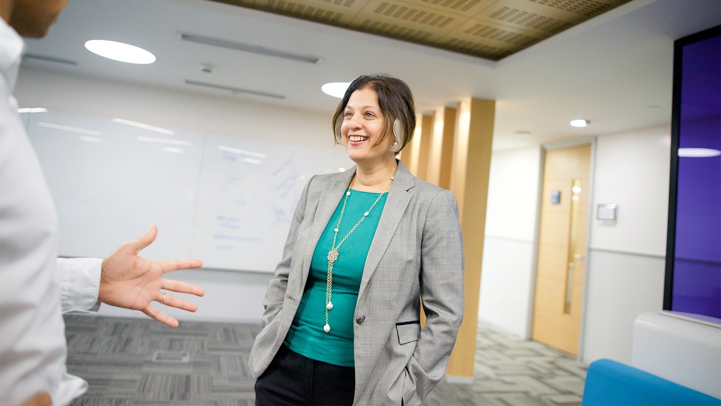 Uma Ratnam Krishnan laughs with a colleague at Barclays Global Service Centre