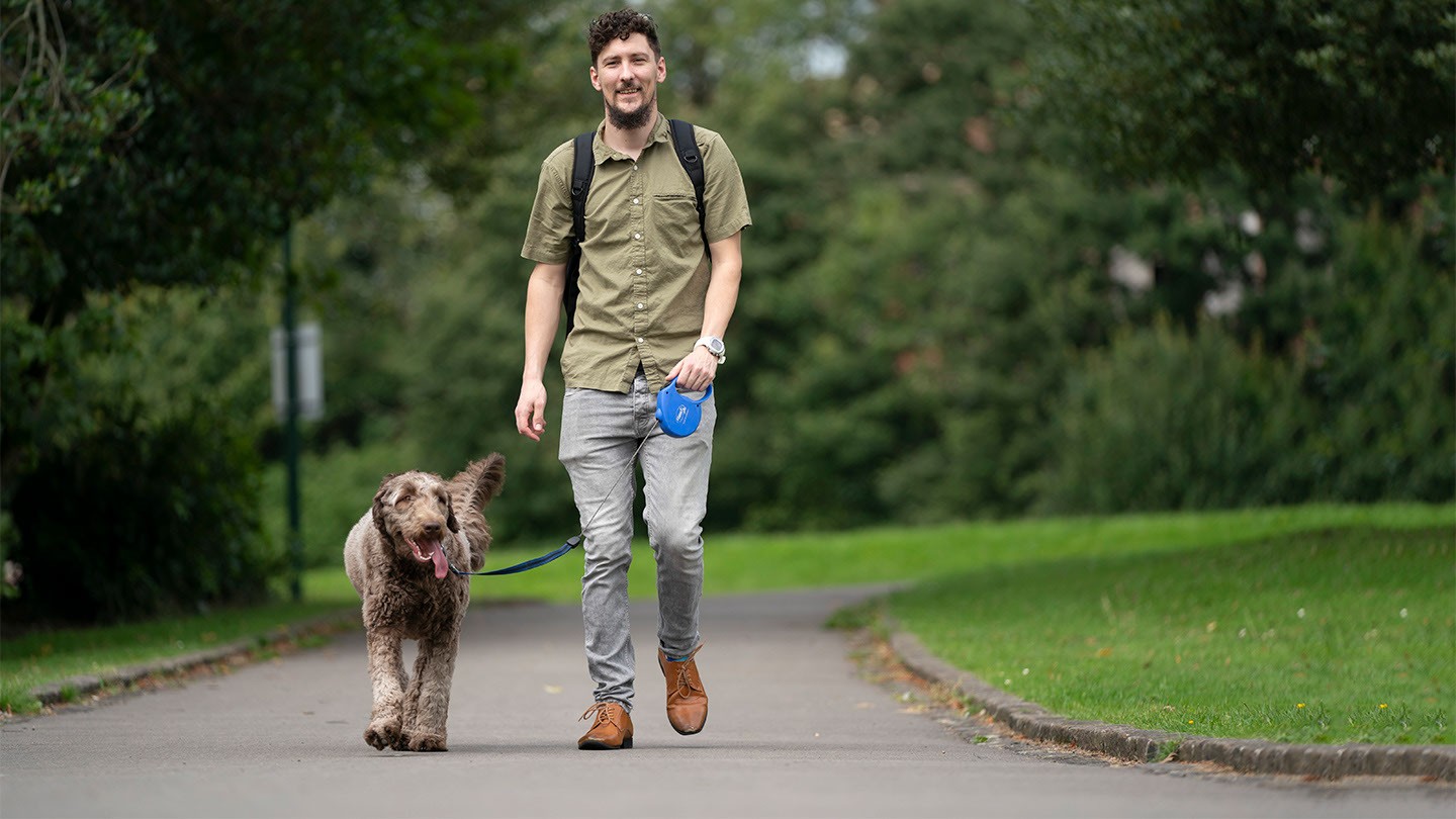 Barclays’ Jonathan Beever walks his dog in a park.