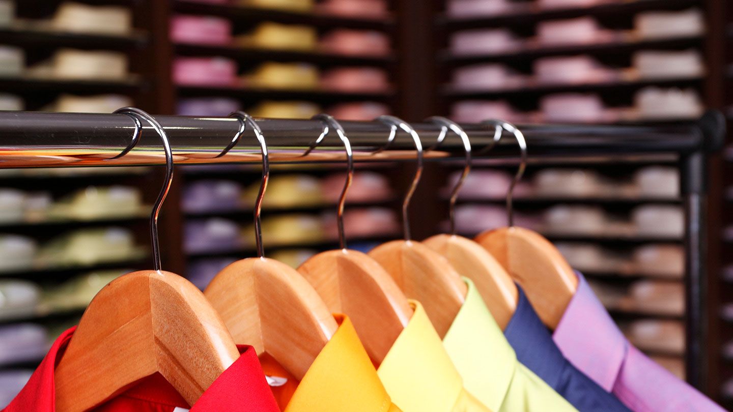 Clothes hanging on a rail.