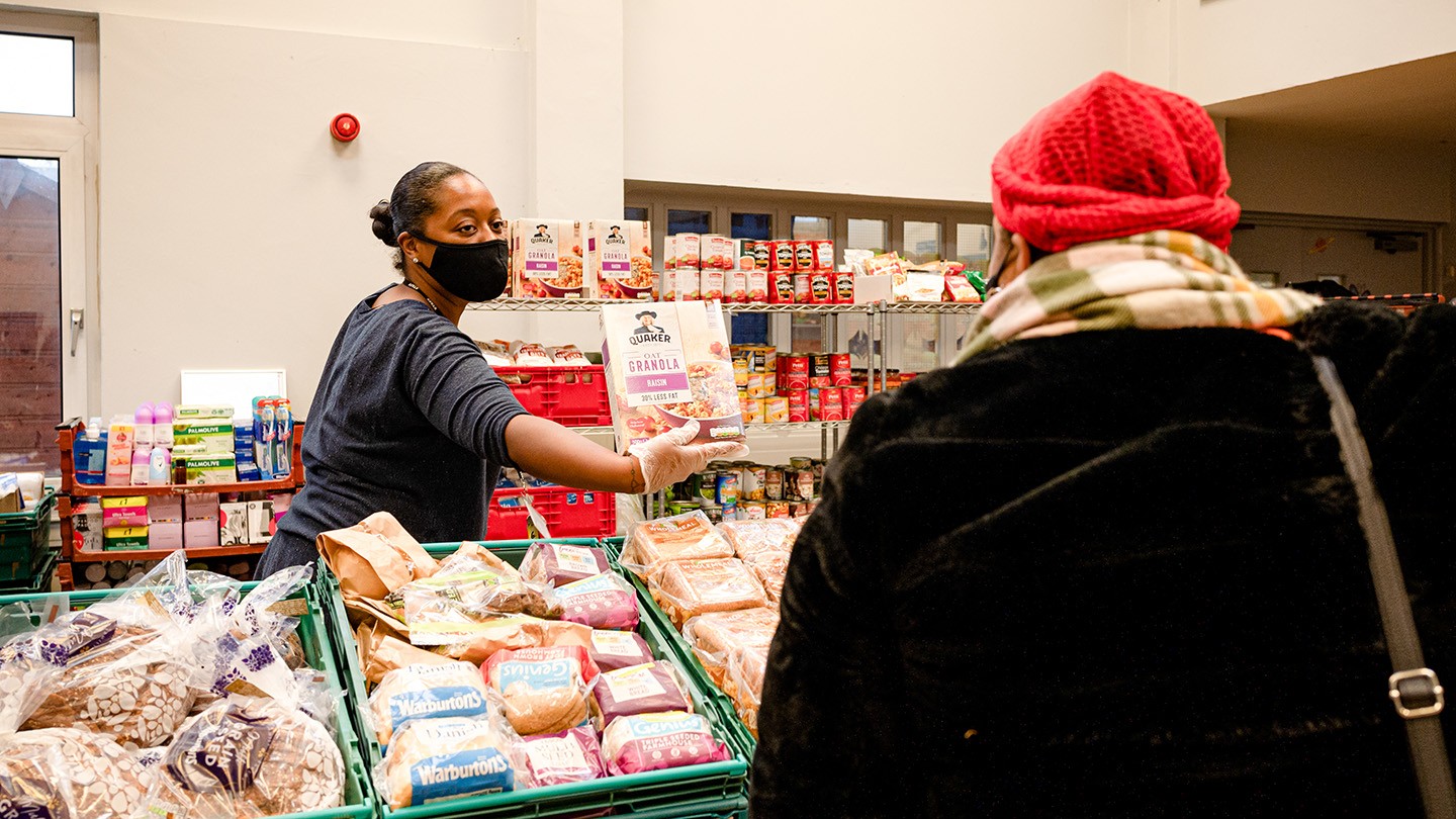 FareShare volunteer handing out food to a charity recipient.