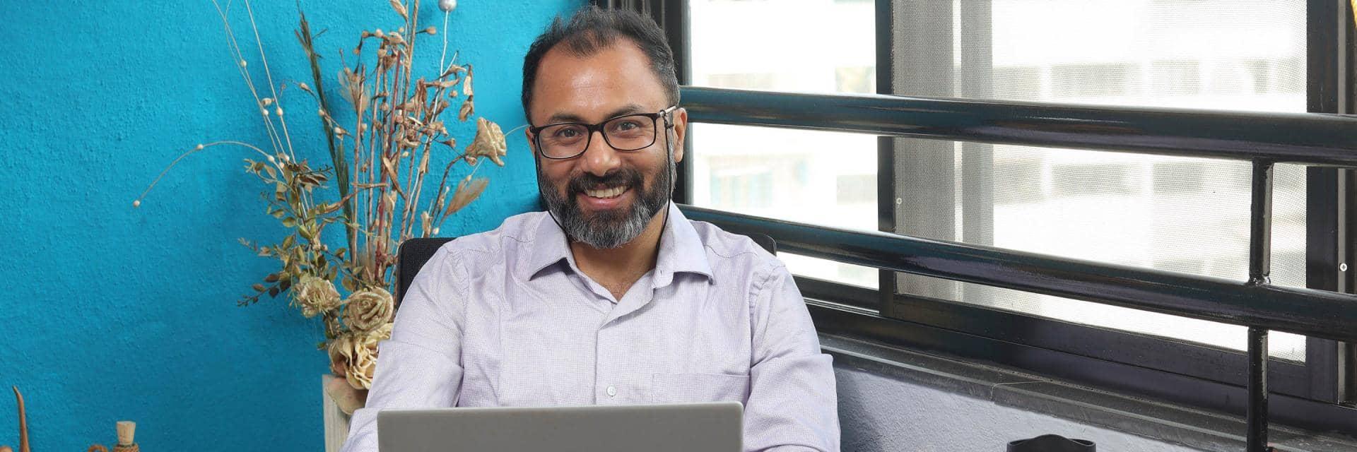 Satyaki Basu, Barclays Data Architect, working at his desk.