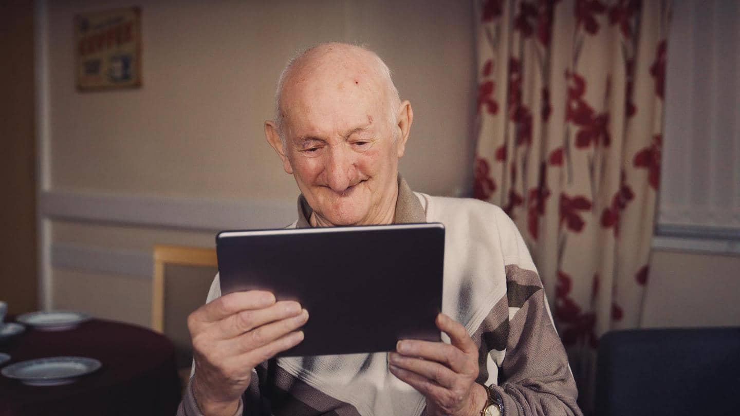 A man looks at a tablet.