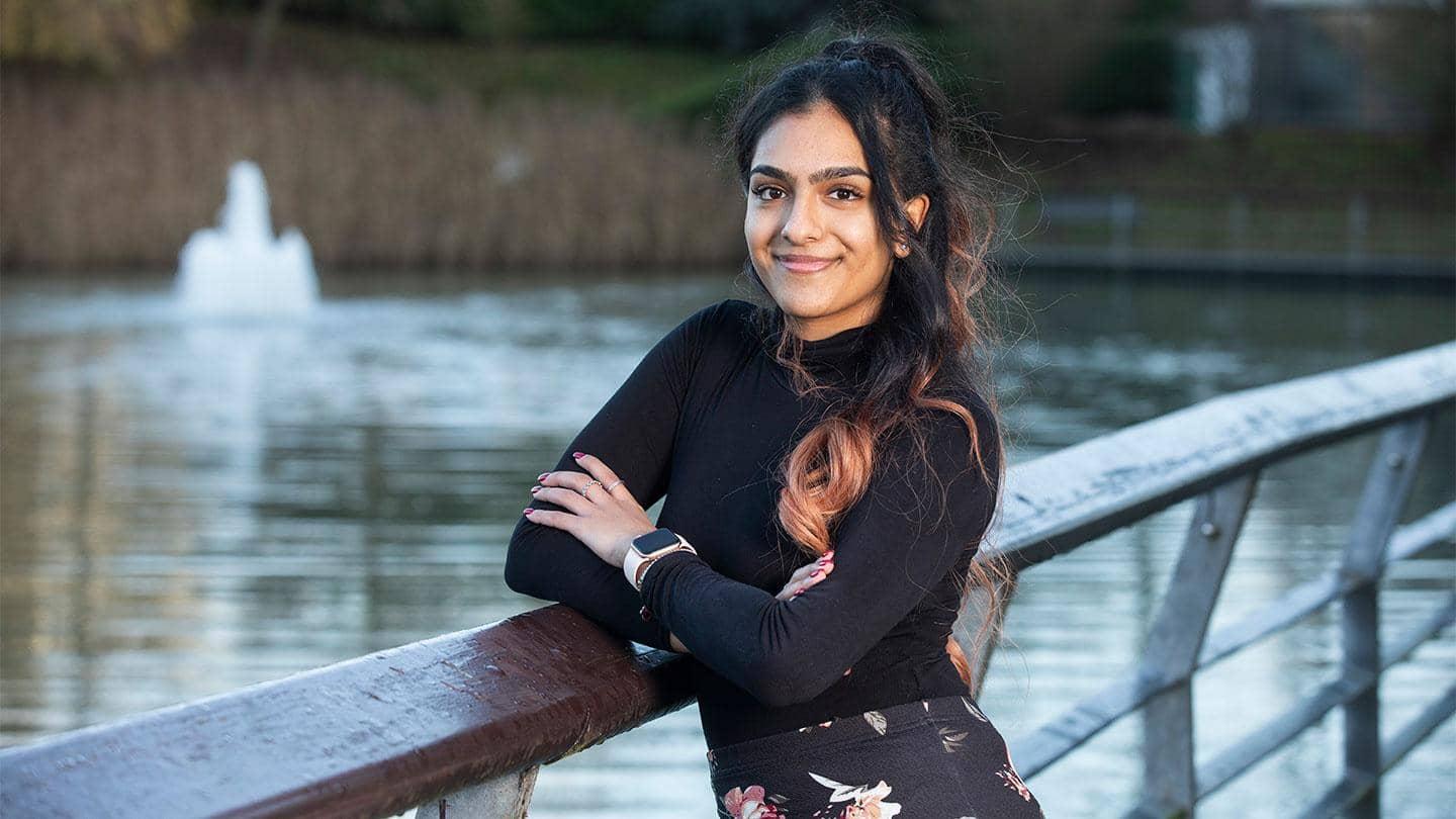 Barclays’ Bhavika Mistry leans on a railing above a body of water.