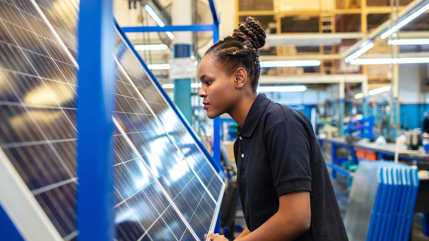 Green industry - woman in solar factory