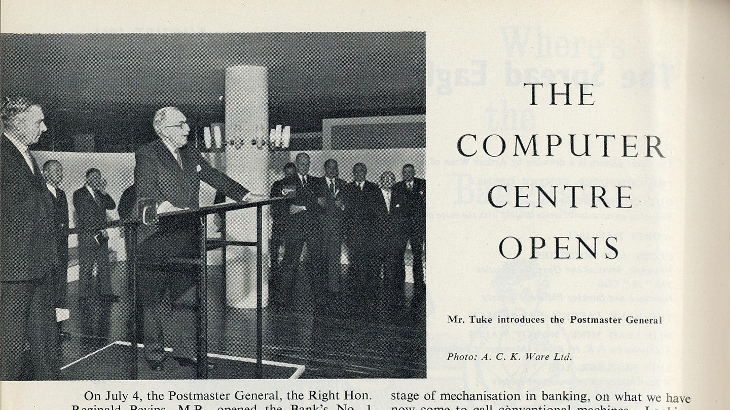 A newspaper clipping of a man speaking to a crowd at Barclays’ computer centre launch. 