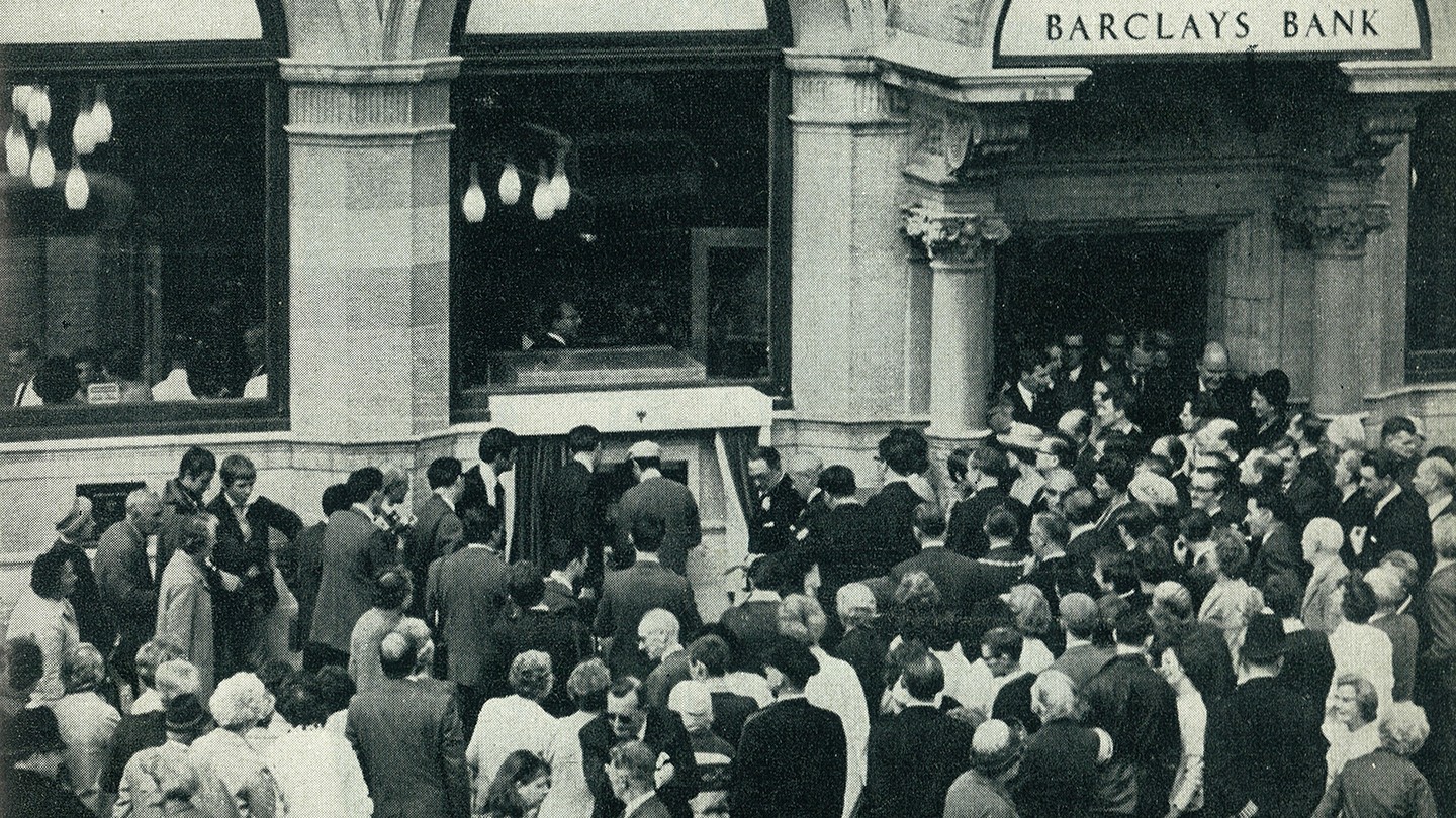 People crowd around Barclaycash, the world’s first automatic cash dispenser.