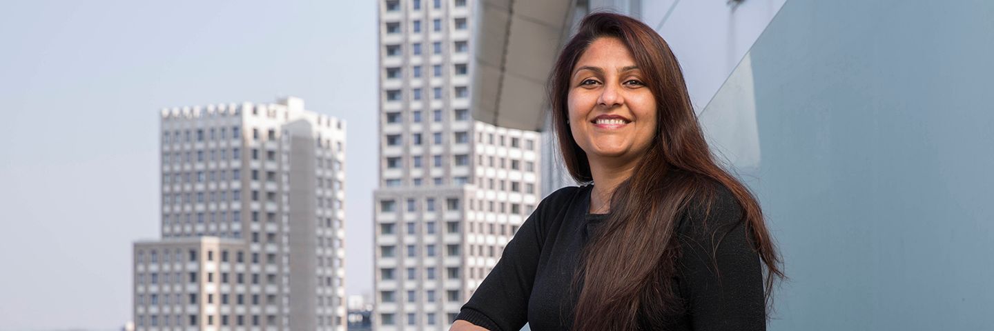 An image of Barclays’ Jyotsna Sekhri standing on a balcony. 