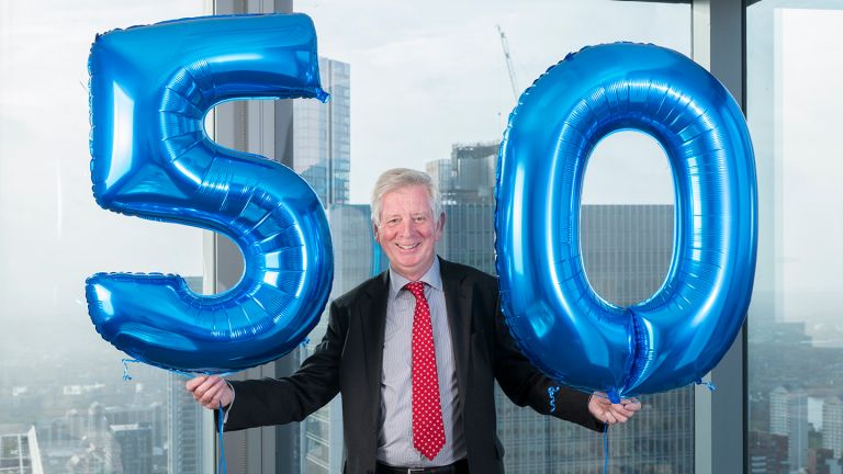 Brendan Jarvis holding large '50' balloons
