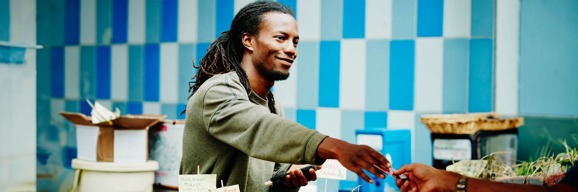 Male shopkeeper behind counter