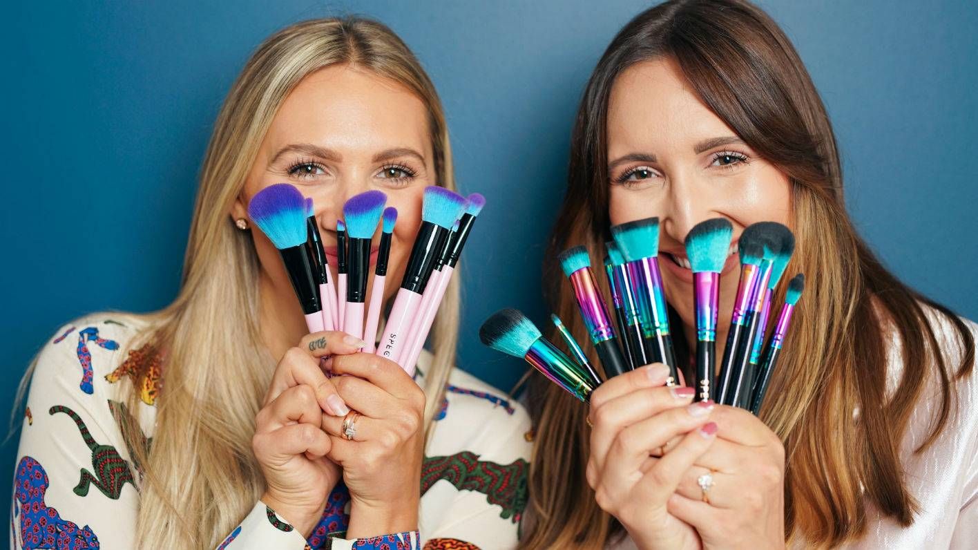 Sophie and Hannah Pycroft holding Spectrum brushes