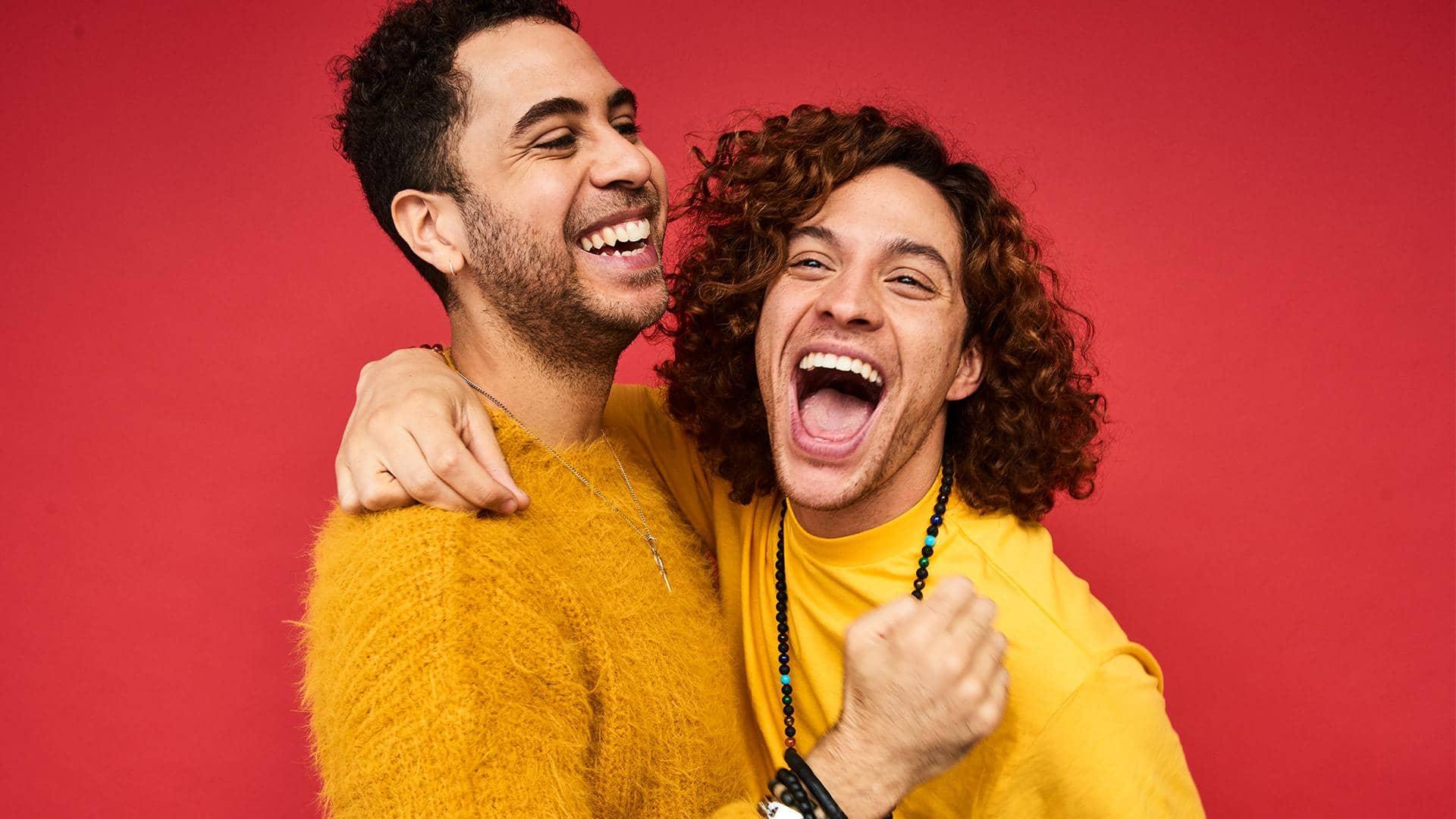 Male couple against a red background
